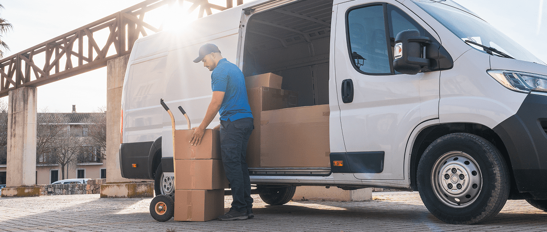Delivery worker unloading boxes from van