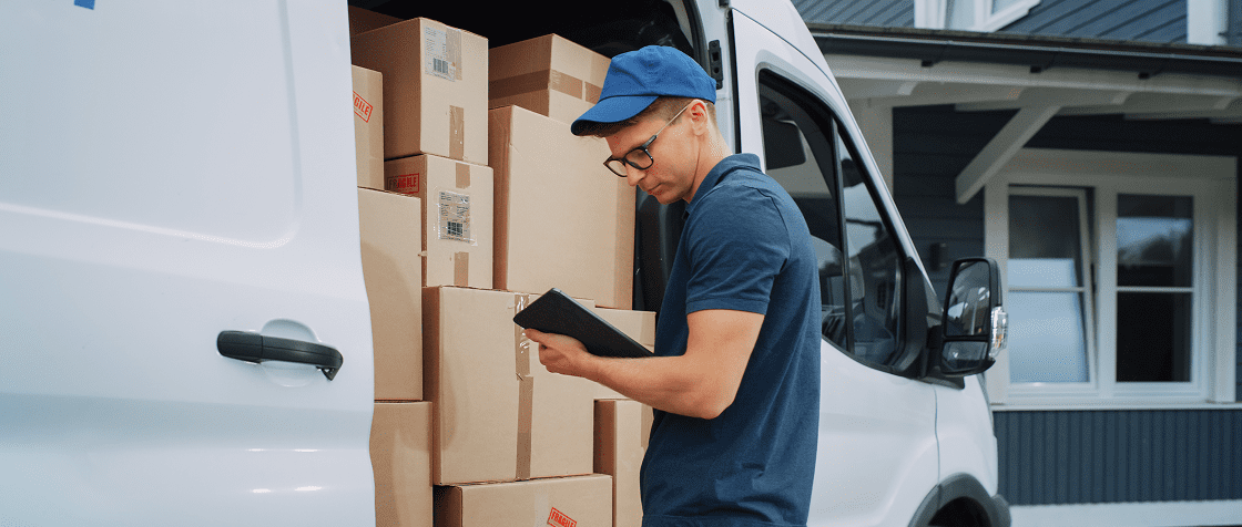 Delivery worker checking packages in van