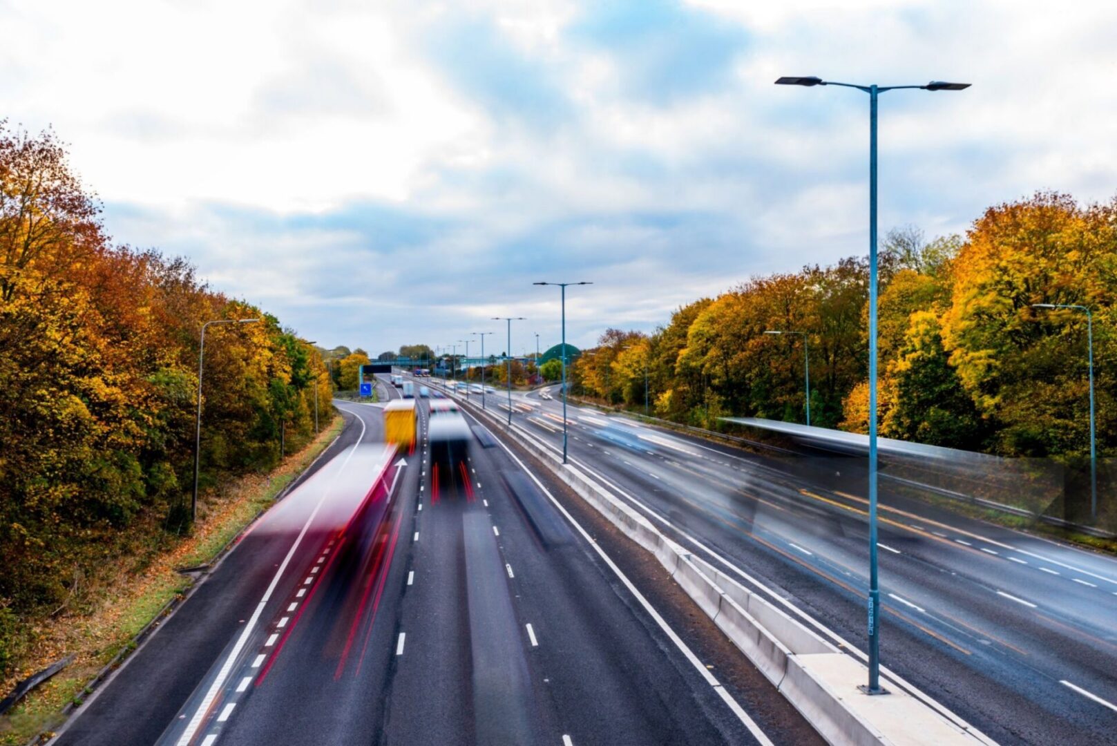 Highway traffic motion blur with fall foliage