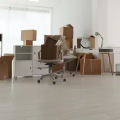 Empty office space with moving boxes and chair